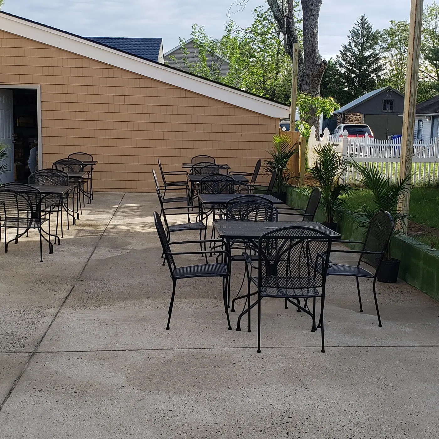 Outdoor tables and chairs on the patio beside Mia's Cafe