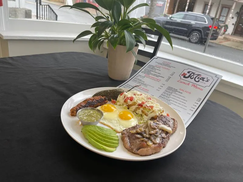 Eggs, avocado and steak at a window table inside Mia's Cafe